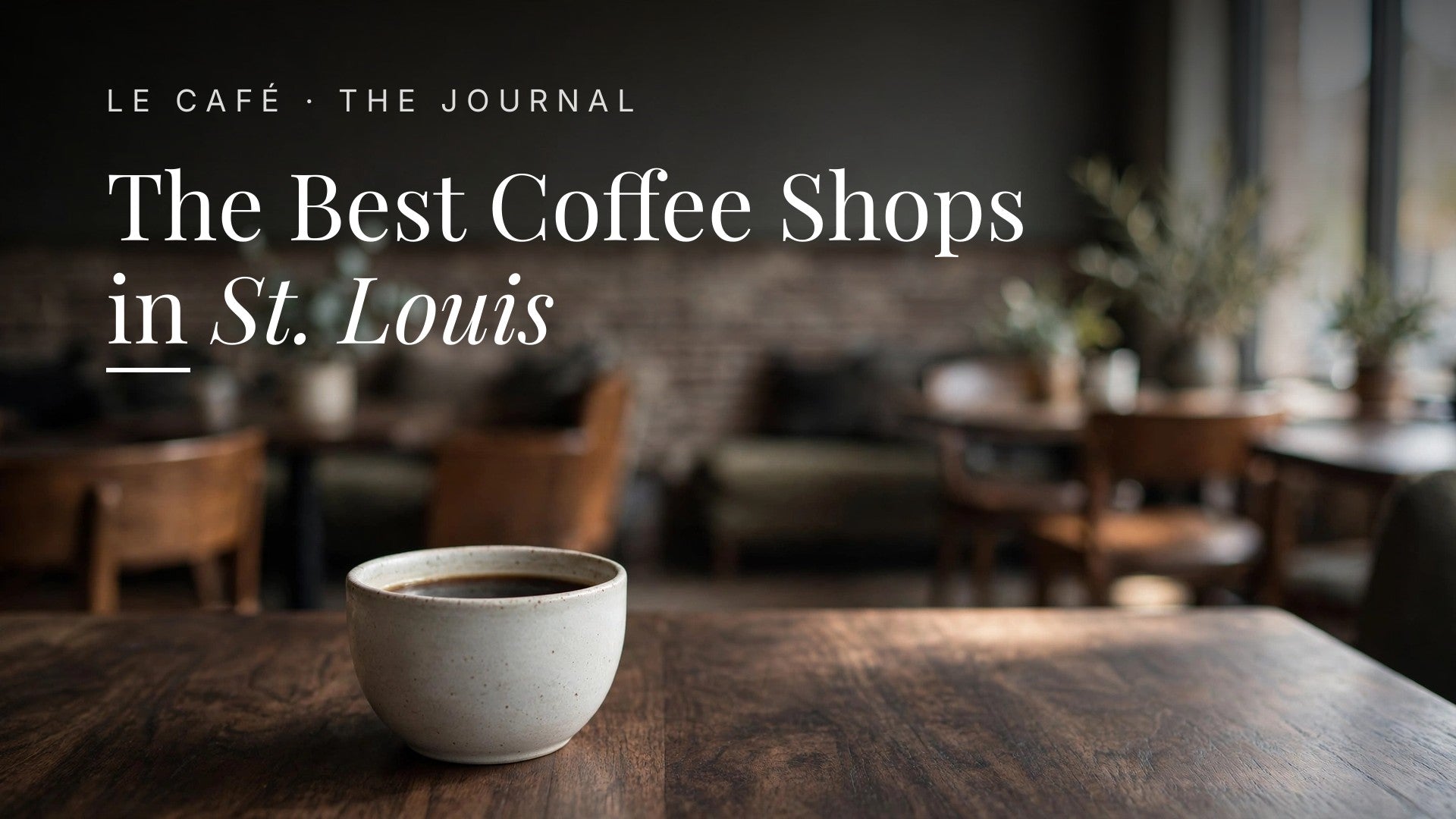 A cup of coffee on a dark wooden table in a St. Louis coffee shop, Le Café Journal header: The Best Coffee Shops in St. Louis