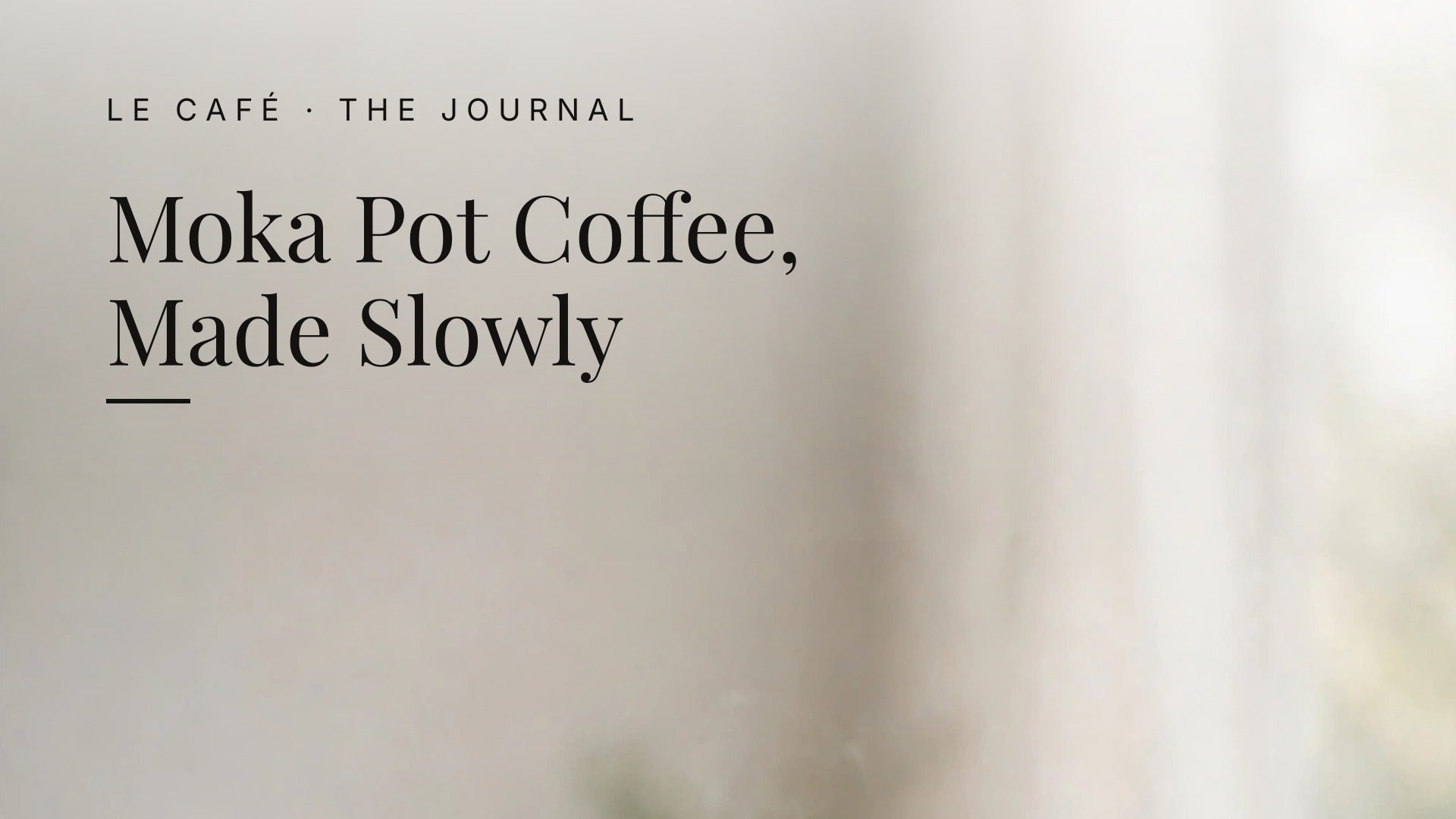 A hand pouring coffee from a stainless steel moka pot into a white ceramic cup on a wooden counter in soft morning light. Le Café Journal header: Moka Pot Coffee, Made Slowly