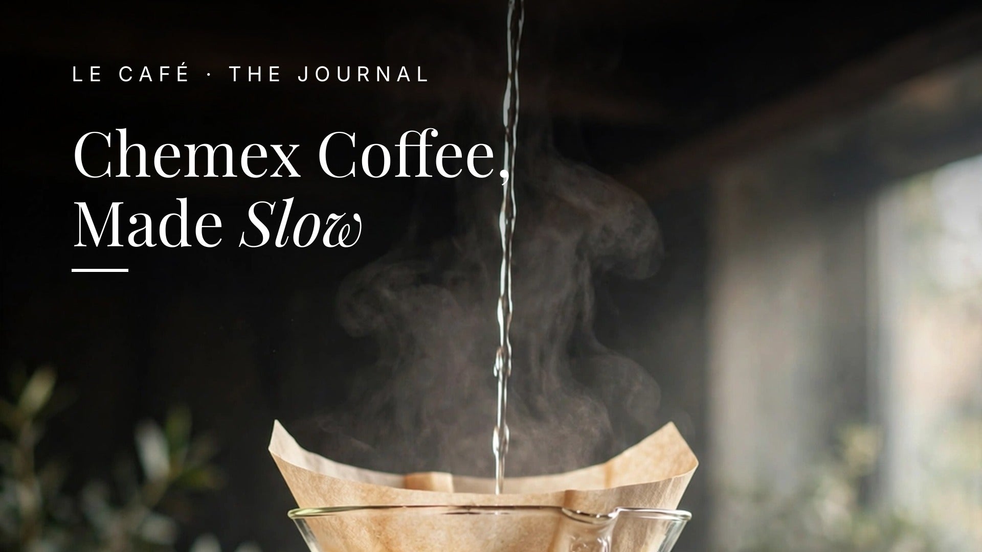 A Chemex brewer with a paper filter pouring coffee on a dark wood table in soft morning light, with whole beans nearby. Le Cafe Journal header: Chemex Coffee, Made Slow